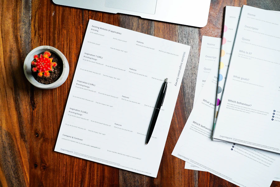 Application forms and a pen on a wooden desk
